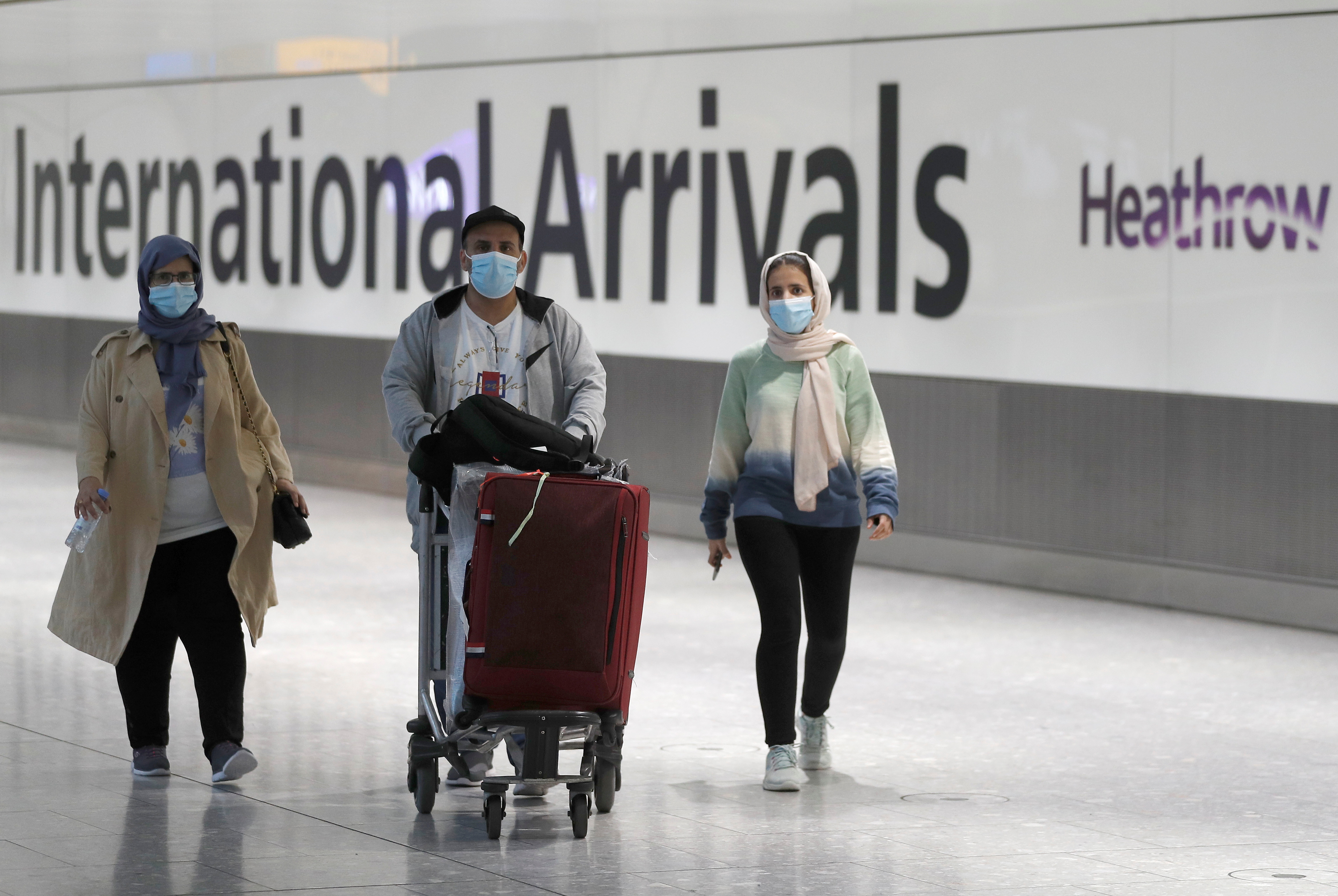 WHO urges travellers to wear masks as new COVID variant spreads